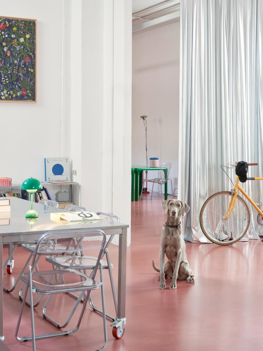 Adatto interior with desk, plants and bicycle